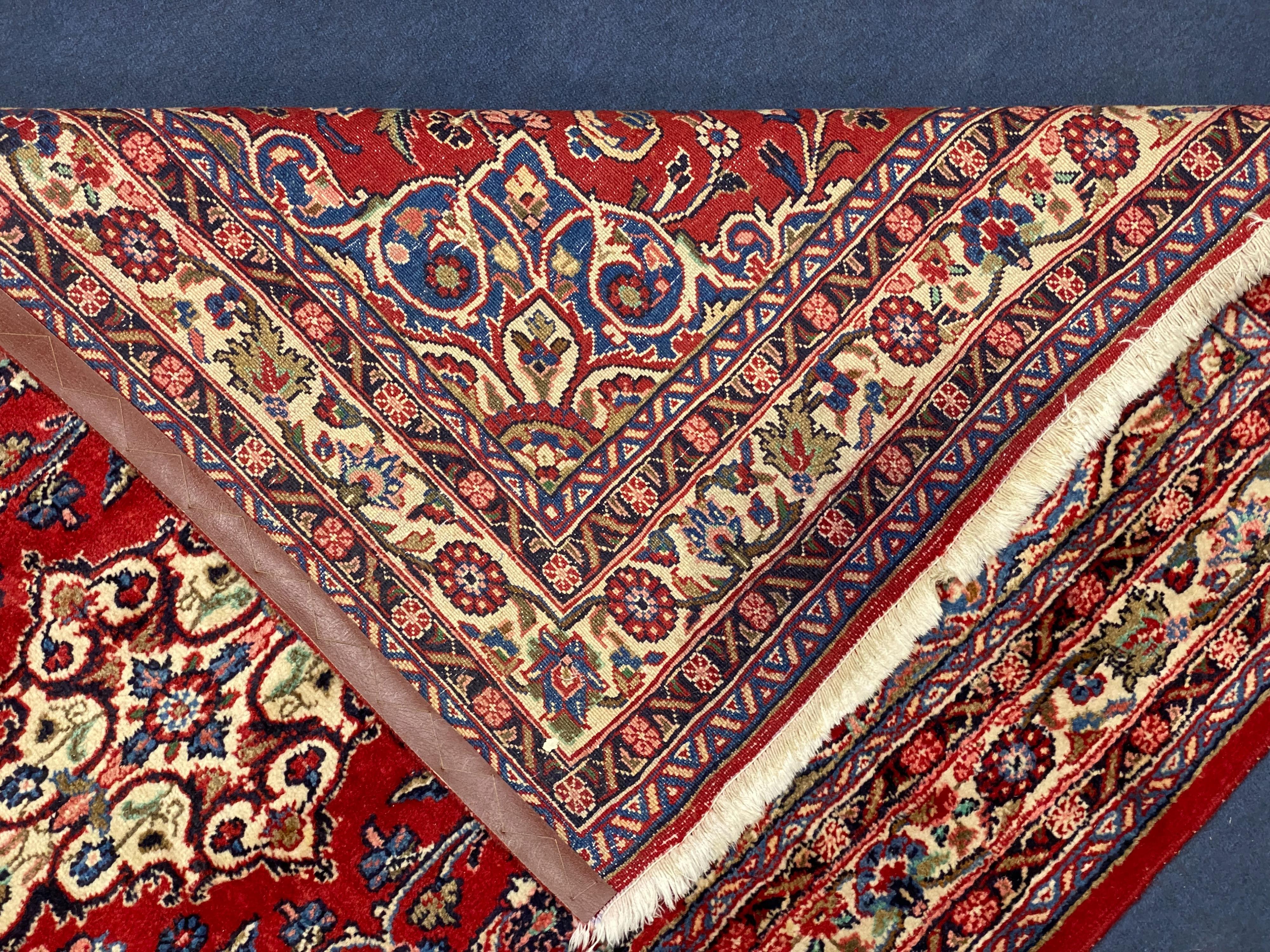 A Northwest Persian red ground rug, 240 cm x 136 cm